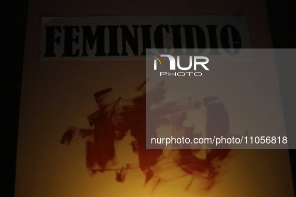 A poster is being viewed in the Zocalo of Mexico City, during an evening before protests on the occasion of International Women's Day in Mex...