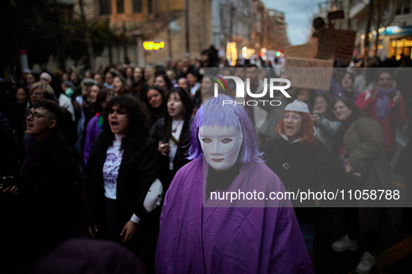 A protester is wearing a mask during the International Women's Day demonstration in Granada, Spain, on March 8, 2024. International Women's...