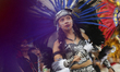 A woman is performing a pre-Hispanic dance in the Zocalo of Mexico City, during a large-sc...