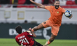 Khalid Muftah Muftah of Al-Rayyan SC is battling for the ball with Oussama Tannane of Umm...