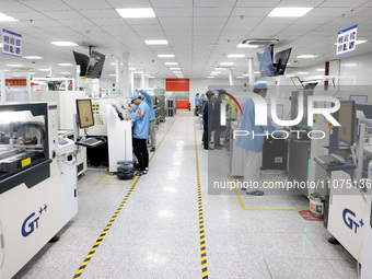 Staff members are producing digital network products in a production workshop of a technology enterprise in Fuzhou, China, on March 14, 2024...