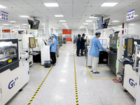 Staff members are producing digital network products in a production workshop of a technology enterprise in Fuzhou, China, on March 14, 2024...