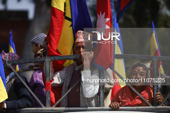 Monarchy supporters in Nepal are riding on the back of a vehicle during a rally organized in Kathmandu, Nepal, on March 14, 2024. Demonstrat...