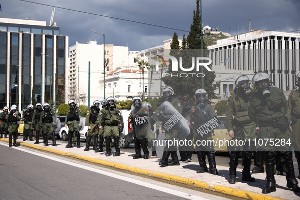 Police is standing in front of the parliament building while demonstrators attend a protest held by 
student associations and educational u...