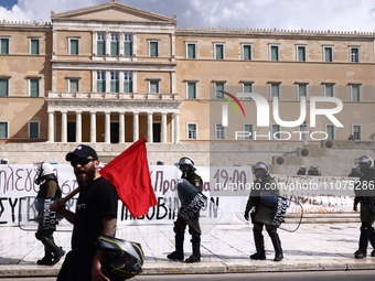 Police is standing in front of the parliament building while demonstrators attend a protest held by 
student associations and educational u...