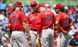 Members of the Boston Red Sox are talking on the field during a game against the Philadelp...