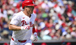 Philadelphia Phillies catcher J.T. Realmuto (10) is running to first base during a MLB spr...