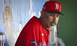 Boston Red Sox manager Alex Cora (13) is looking at the players in the dugout during a MLB...
