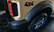 The 4X4 Thar Earth Edition is being showcased in a new golden color at a Mahindra showroom...