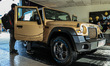 The 4X4 Thar Earth Edition is being showcased in a new golden color at a Mahindra showroom...