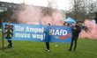 Members of AfD are holding a banner that reads ''The Traffic Light Must Go'' while a count...