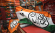 A person is arranging various party flags inside a shop in preparation for the Lok Sabha E...