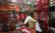 A person is selling political party flags inside a shop in Kolkata, India, on March 17, 20...