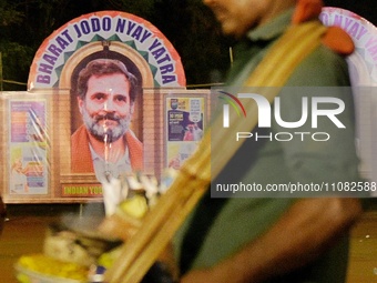 A peanut seller is passing by a cut-out of Indian National Congress leader Rahul Gandhi during the Bharat Jodo Nyay Yatra gathering ahead of...