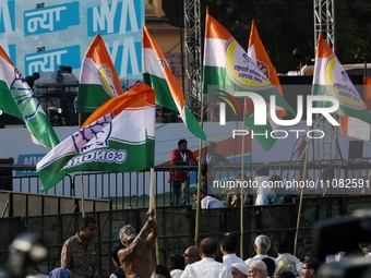 A supporter of the Indian National Congress is waving a flag during the Bharat Jodo Nyay Yatra gathering ahead of the Indian Lok Sabha Elect...