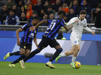 Khvicha Kvaratskhelia of Napoli is controlling the ball during the Serie A soccer match between Inter FC and SSC Napoli at Stadio Meazza in...