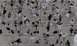 Female students from various dance schools are participating in a massive ballet class led...
