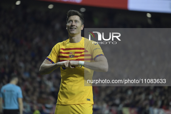 Barcelona's Polish forward Robert Lewandowski is scoring his team's second goal during the Spanish league football match between Club Atleti...