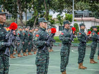 Newly joined SWAT team members are receiving weapons from veteran members during the 2024 SWAT team induction ceremony in Nanning, Guangxi P...