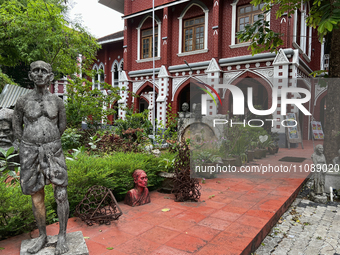 Sculptures are standing outside the Kerala College of Fine Arts building in Thiruvananthapuram, Kerala, India. (