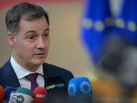 Belgium's Prime Minister Alexander De Croo is speaking to the press as he arrives to attend the European Council Summit in Brussels, Belgium...