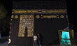 Two young Iranian men are posing with a scale model of the Kaaba in a park in downtown Teh...