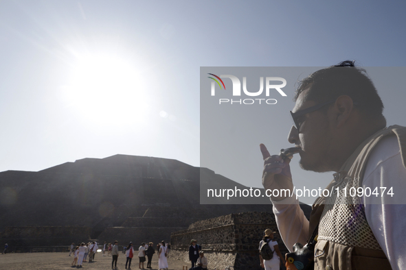 A person is blowing a whistle during the spring equinox in the archaeological zone of Teotihuacan in the Municipality of Teotihuacan, in the...