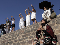 People are raising their hands to fill themselves with energy during the spring equinox in the archaeological zone of Teotihuacan, in the Mu...