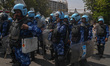 Rapid Action Force (RAF) personnel are standing guard on a road where supporters of the Aa...
