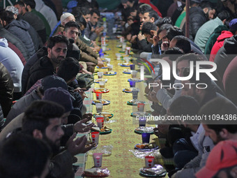 People are gathering to break their fast outside Bilal Masjid, located in the heart of Srinagar, Kashmir, India, on March 23, 2024. A member...