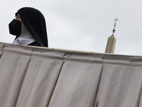 A nun before the Palm Sunday mass at Saint Peter's Square in Vatican on March 24, 2024. (