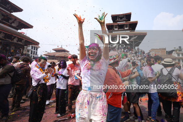 A foreign national is dancing to the beats of traditional Nepali musical instruments as she participates in celebrating Holi, the festival o...