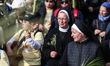 Christian worshippers march down a road, overlooking the Dome of the Rock mosque at the Al...