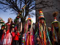 People wearing colourful costumes attend traditional Palm Sunday celebration at the Main Square in Krakow, Poland on March 24, 2024. During...