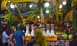 People are buying fruit juice for Iftar meals at a marketplace during the fasting month of...