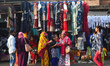 People are buying new dresses for the upcoming Eid al-Fitr festival at a marketplace durin...