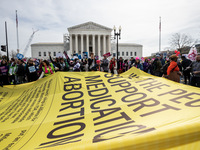 Pro-choice demonstrators display a petition signed by more than 500,000 people to maintain FDA approval of the abortion medication mifeprist...
