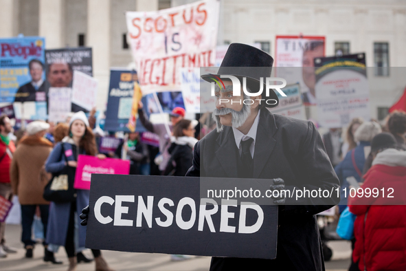 A person dressed as President Abraham Lincoln attends pro-choice and anti-abortion demonstrations at the Supreme Court as it hears oral argu...