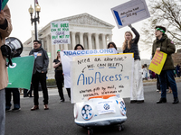 Pro-choice activists demonstrate at the Supreme Court before it hears oral arguments in a case that could end access to the abortion medicat...