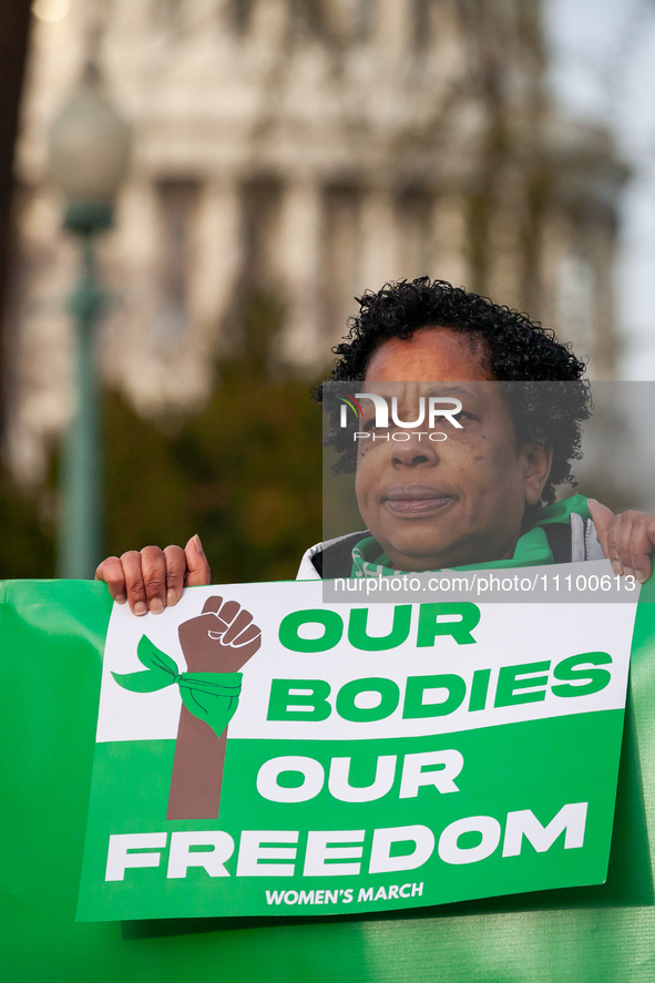 One of hundreds of pro-choice activists demonstrates outside the Supreme Court before it hears oral arguments in a case that could end acces...