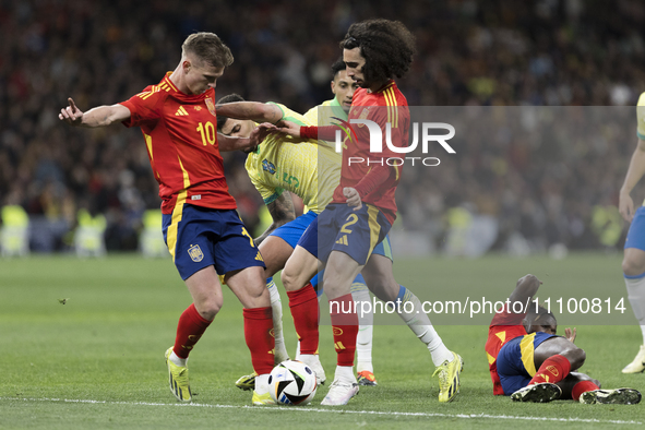 Dani Olmo of Spain, Bruno Guimaraes, and Marc Cucurella of Spain are fighting for the ball during the friendly match between Spain and Brazi...