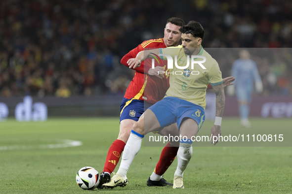 Aymeric Laporte of Spain and Lucas Paqueta of Brazil are fighting for the ball during the friendly match between Spain and Brazil at Santiag...