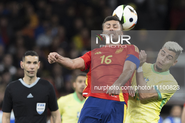 Rodrigo Hernandez of Spain and Andreas Pereira are fighting for the ball during the friendly match between Spain and Brazil at Santiago Bern...