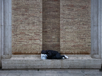 A person sleeps in Rome, Italy on March 25, 2024. (