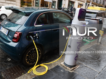 Electric Fiat 500 car is seen charging at Enel X charging point in Rome, Italy on March 26, 2024. (