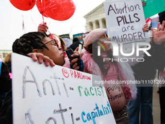 Abortion rights demonstrators face off with counterprotestors outside of the Supreme Court in Washington, D.C. on March 26, 2024 as the high...