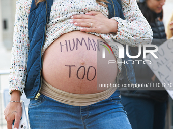A pregnant anti-abortion rights demonstrator protests outside of the Supreme Court in Washington, D.C. on March 26, 2024 as the high court h...