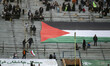 People in Iran are placing a massive Palestinian flag at the Azadi (Freedom) Stadium durin...