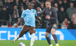 Jeremy Doku of Manchester City is holding off James Bowden of West Ham United during the I...