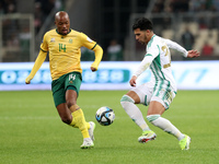 Monsef Bakrrar (R) of Algeria is in action with Goodman Mosele of South Africa during the international friendly match in Algiers, Algeria,...